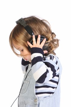 beauty a little girl listening music on white background