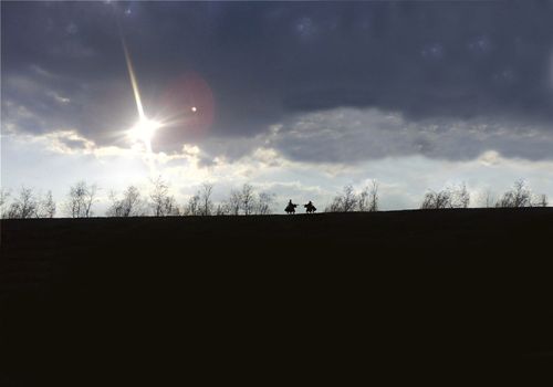 Knights fight on a wide plain with the sun in the background