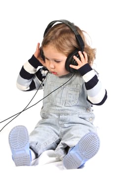 beauty a little girl listening music on white background