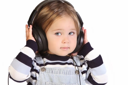 beauty a little girl listening music on white background