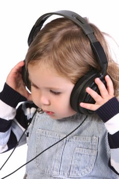 beauty a little girl listening music on white background