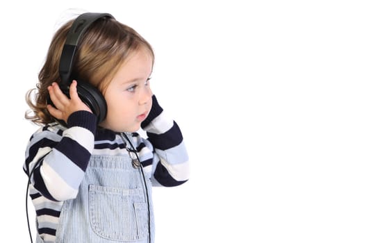 beauty a little girl listening music on white background