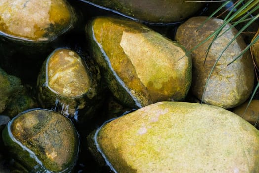 Yellow boulders laying in water