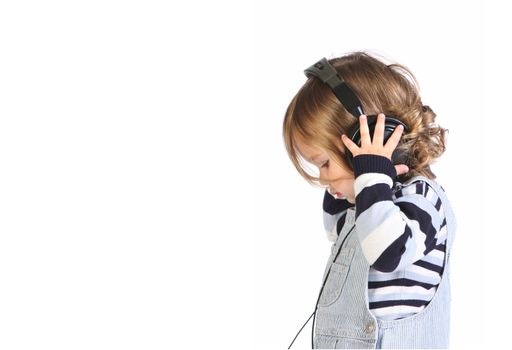 beauty a little girl listening music on white background