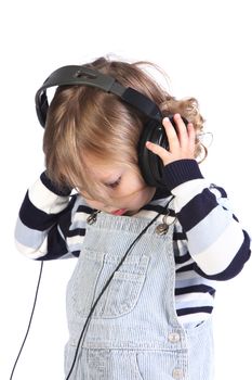 beauty a little girl listening music on white background