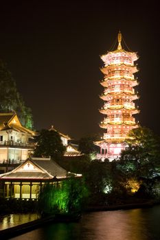 Night image of the Mulong Lake pagoda and buildings at Guilin, China.