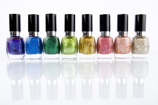 Group of nail polishes of different colors on white background