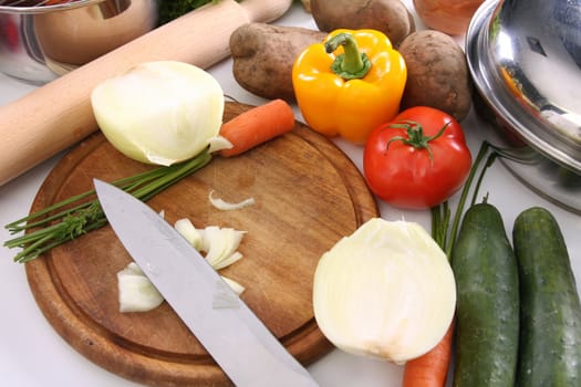 preparing lunch and cutting onion with knife