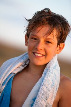 people series: portrait of smiling boy with towel