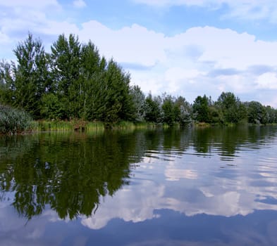 picture of a blue lake and green trees