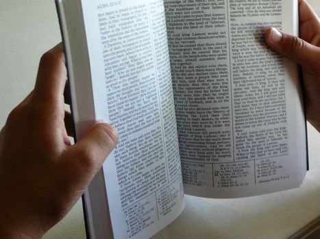 Open Book Of Mormon in the hands of an African-American