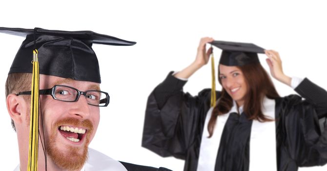 two successful student in graduation gowns on white background