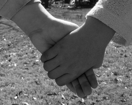 Close-up of children holding hands