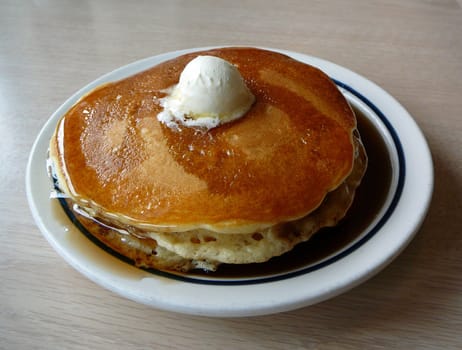 Stack of pancakes with syrup and butter