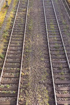 Two parallel railway tracks in embankment of gravel.