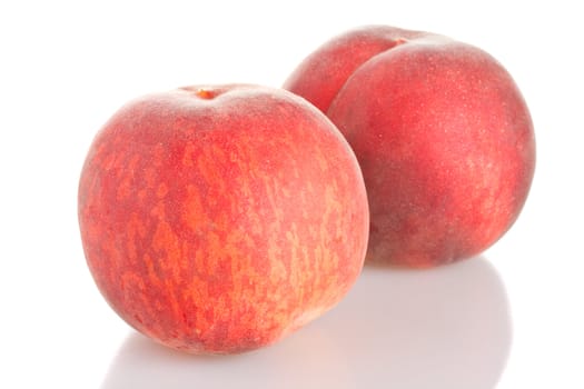 two ripe red peaches, isolated on white