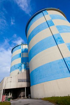 Storage depot facility with blue-white concrete silos.