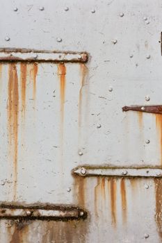 Grungy old steel hatch door secured by padlock