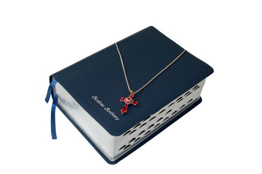 Bible and cross necklace on white background