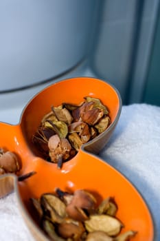 dried aromatic in a unique orange bowl in the bathroom as decoration