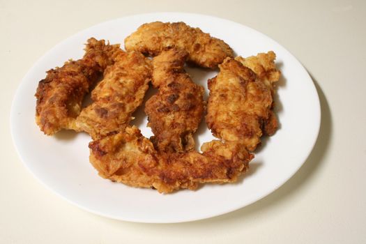 Plate of chicken tenders isolated on white background