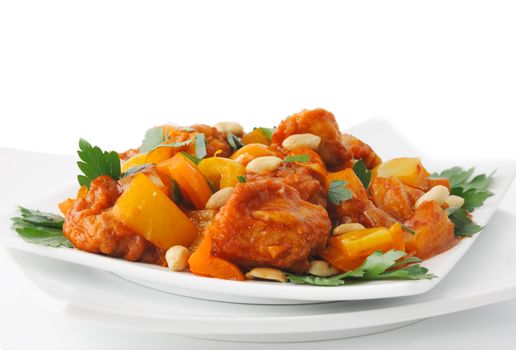 Pork in batter with pineapple and bell pepper in sweet and sour sauce with peanuts