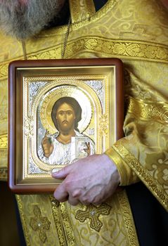 Priest with icon Jesus Christ on ceremony of wedding