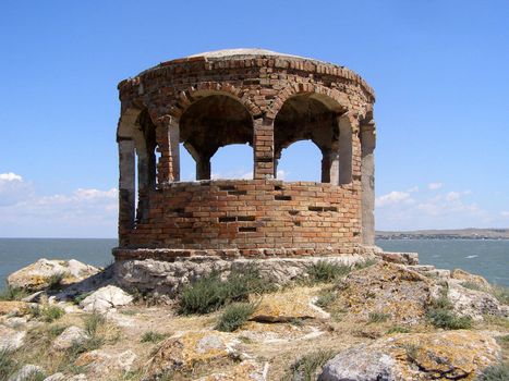 The summerhouse from the brick of centuries-old remoteness costs on the edge of cliff in Azov sea. 