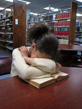 Girl sleeping in the library