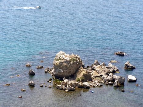 the heap of stones is located on the sand bar of Black sea near the Sudak. Tourists far rest, they get a tan on the stones and roll on the launch. 