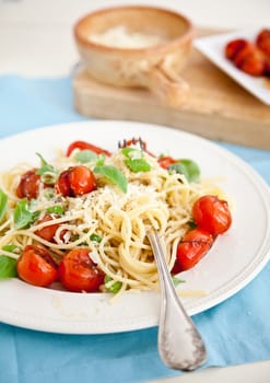 Delicious fresh pasta with tomatoes, basil and parmezan