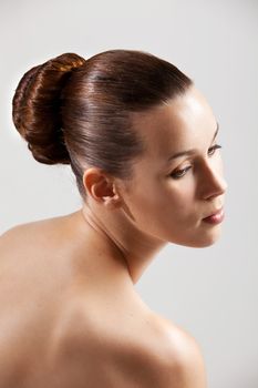 Beautiful and elegant woman with bare shoulders and stylish hair