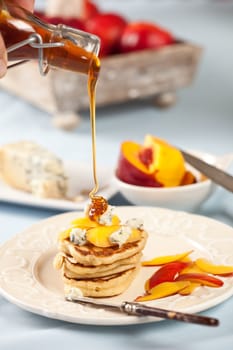 Delicious small blini's with nectarine, blue cheese and honey