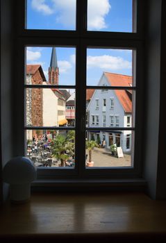 view through window on city center with a church