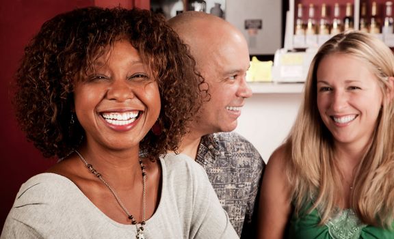 Smiling African American Woman in a Restaurant with friends