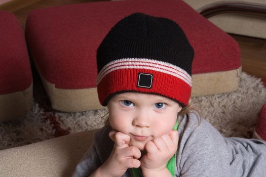 little boy with  hat looking at us with his