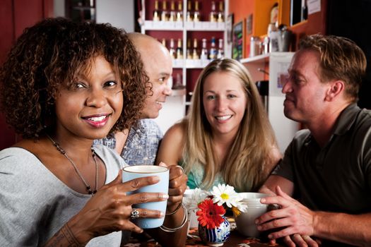 Pretty African American Woman in Coffee House with Friends