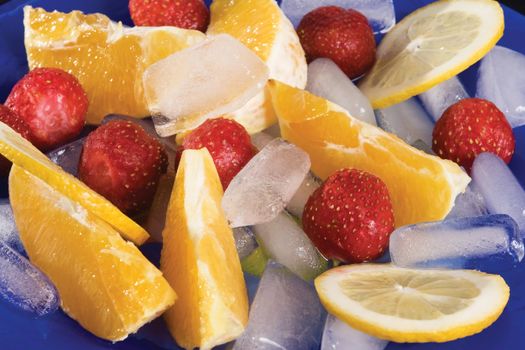 fruit assorted  are with to rest ice upon blue plate