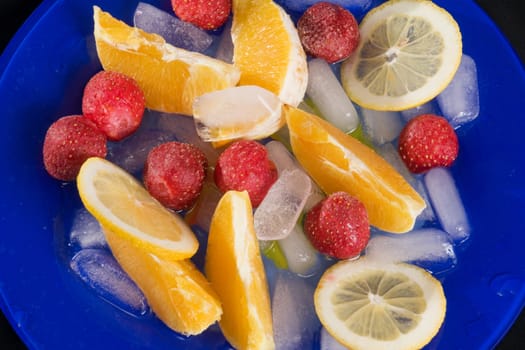 fruit assorted  are with to rest ice upon blue plate