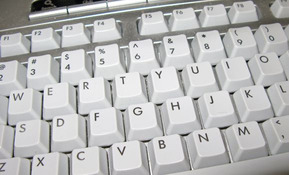 A dusty white keyboard of a computer.