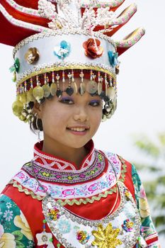 Image of a young Chinese girl in traditional ethnic dress at Yao Mountain, Guilin, China.