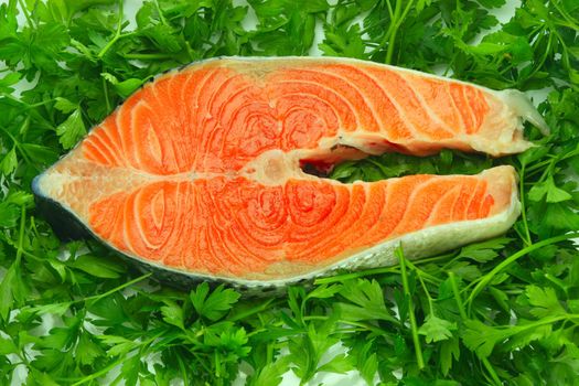 Fresh salmon steak on the salad leaf