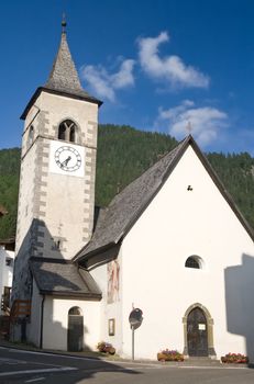 small church in Canazei, Trentino, Italy. Canazei is a famuos small town in val di Fassa, Italian dolomites. Photo taken with polarizer filter