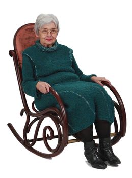 Old woman sitting on a wooden rocking chair isolated against a white background.