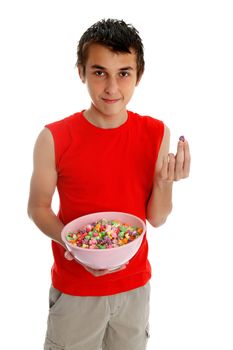 Smiling boy holding a bowl of sugar coated popcorn.  White background.