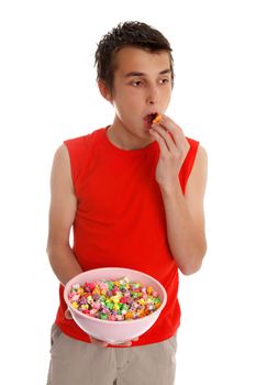 A boy putting a piece of popcorn in his mouth.