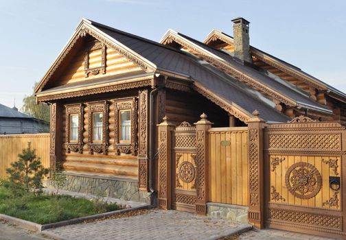Beautiful brown wooden house with carved ornament in front, Russia