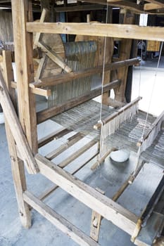 Image of an old wooden weaving machine seen at Shangrila Park, Guilin, China.