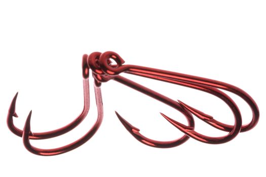 Isolated macro image of red fish hooks.