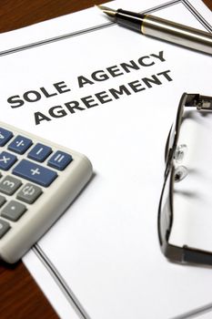Image of a sole agency agreement on an office table.